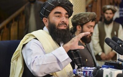 Taliban spokesperson Zabihullah Mujahid (L) gestures as he speaks during the first press conference in Kabul on August 17, 2021, following the Taliban's stunning takeover of Afghanistan. (Hoshang Hashimi / AFP)