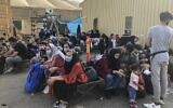 People wait to be evacuated from Afghanistan at the airport in Kabul on August 18, 2021 following the Taliban stunning takeover of the country. (AFP)