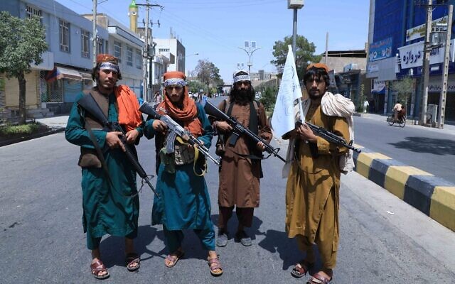 Illustrative: Taliban fighters stand guard along a road in Herat on August 19, 2021, following the Taliban's takeover of Afghanistan. (Aref Karimi/AFP) Illustrative: Taliban fighters stand guard along a road in Herat on August 19, 2021, following the Taliban's takeover of Afghanistan. (Aref Karimi/AFP)