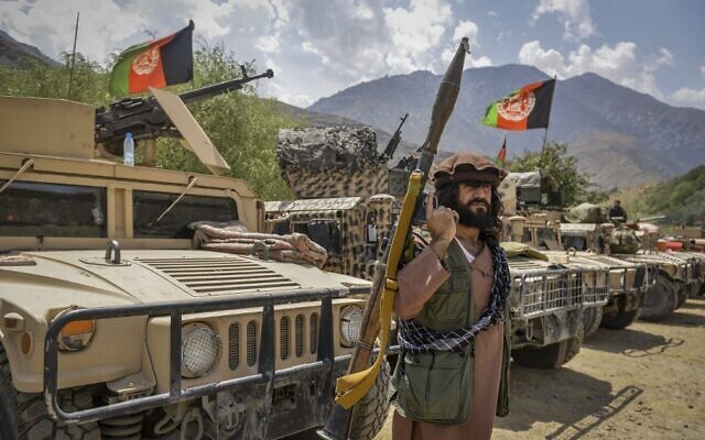 An armed Afghan man supporting the Afghan security forces against the Taliban stands next to humvees at Parakh area in Bazarak, Panjshir province, on August 19, 2021. (Ahmad Sahel Arman/AFP) An armed Afghan man supporting the Afghan security forces against the Taliban stands next to humvees at Parakh area in Bazarak, Panjshir province, on August 19, 2021. (Ahmad Sahel Arman/AFP)