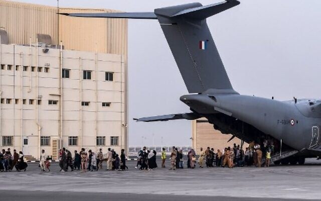 File: People walk on the tarmac as they disembark from a Airbus A400M military transport aircraft at the French military air base near Abu Dhabi, on August 23, 2021, after being evacuated from Kabul. (Bertrand Guay/AFP) File: People walk on the tarmac as they disembark from a Airbus A400M military transport aircraft at the French military air base near Abu Dhabi, on August 23, 2021, after being evacuated from Kabul. (Bertrand Guay/AFP)