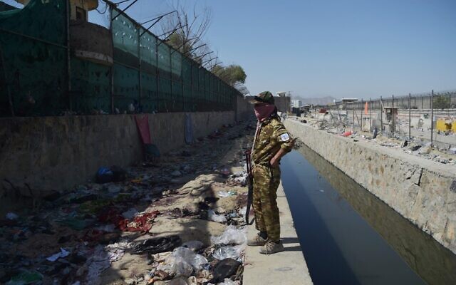 A Taliban fighter stands guard at the site of the August 26 twin suicide bombs, which killed scores of people including 13 US troops, at Kabul airport on August 27, 2021. (WAKIL KOHSAR / AFP) A Taliban fighter stands guard at the site of the August 26 twin suicide bombs, which killed scores of people including 13 US troops, at Kabul airport on August 27, 2021. (WAKIL KOHSAR / AFP)