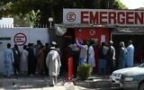 People gather to check on missing relatives a day after a twin suicide bombs attack, which killed scores of people including 13 US troops outside Kabul airport, at a hospital run by Italian NGO Emergency in Kabul on August 27, 2021. (Aamir QURESHI / AFP)