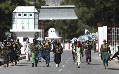 Taliban fighters walk at the main entrance gate of Kabul airport, on August 28, 2021. (Wakil Kohsar/AFP)