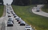US residents drive north (L) on Interstate Highway 55 near Magnolia, Mississippi, as they evacuate away from New Orleans on August 28, 2021, before the arrival of Hurricane Ida. (Photo by Patrick T. FALLON / AFP)