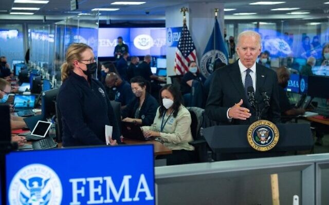 US President Joe Biden speaks about Hurricane Ida alongside FEMA Administrator Deanne Criswell (L) during a visit to FEMA Headquarters in Washington, DC, August 29, 2021. (Photo by SAUL LOEB / AFP)