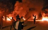 Palestinians burn tires on August 30, 2021 during a protest along the border fence with Israel. (MOHAMMED ABED / AFP)