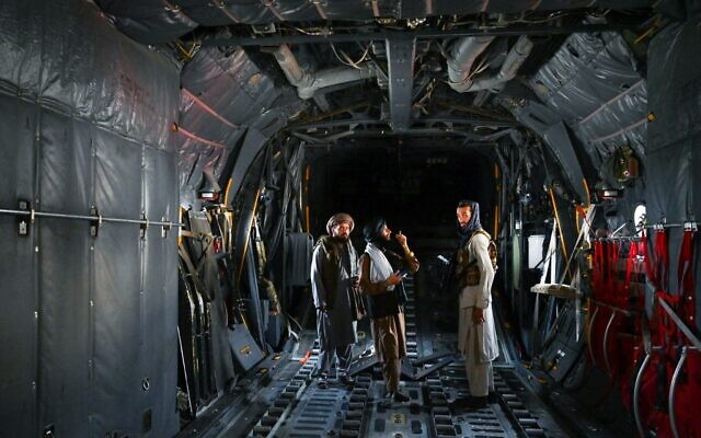 Taliban fighters stand inside an Afghan Air Force aircraft at the airport in Kabul on August 31, 2021 (Wakil KOHSAR / AFP)