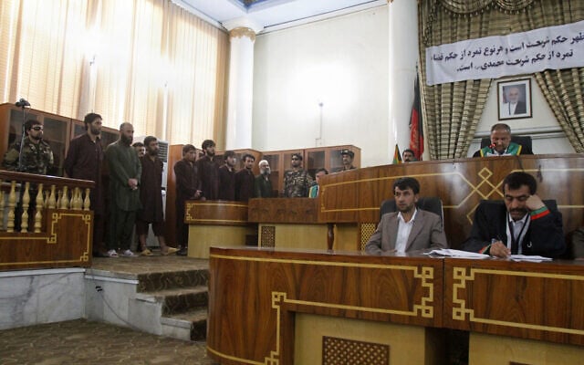 Defendants attend a trial at the Primary Court in Kabul, Afghanistan, on May 6, 2015. The sign in Dari behind the judges reads, "verdicts are based on Sharia (law), any rebellion against the verdict is rebellion against (the Prophet) Muhammad." (AP/Allauddin Khan) Defendants attend a trial at the Primary Court in Kabul, Afghanistan, on May 6, 2015. The sign in Dari behind the judges reads, "verdicts are based on Sharia (law), any rebellion against the verdict is rebellion against (the Prophet) Muhammad." (AP/Allauddin Khan)