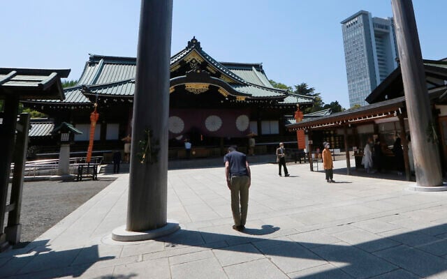 Illustrative -- A worshipper bows at Yasukuni Shrine in Tokyo, April 21, 2021 (AP Photo/Koji Sasahara) Illustrative -- A worshipper bows at Yasukuni Shrine in Tokyo, April 21, 2021 (AP Photo/Koji Sasahara)