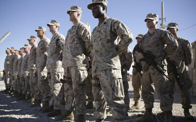 In this Jan. 15, 2018, file photo, US Marines watch during the change of command ceremony at Task Force Southwest military field in Shorab military camp of Helmand province, Afghanistan. (AP Photo/Massoud Hossaini, File)