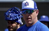 Israel Olympic baseball manager Eric Holtz watches his team practice at Salt River Fields spring training facility, Wednesday, May 12, 2021, in Scottsdale, Ariz. (AP/Matt York)