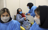 A woman receives the Sinopharm COVID-19 vaccine at the Iran Mall shopping center in Tehran, Iran, Monday, May 17, 2021. (AP/Ebrahim Noroozi)