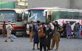 Illustrative: Afghans wait to board a bus to travel to Iran, in Kabul, Afghanistan, June 30, 2021. (AP/Rahmat Gul)