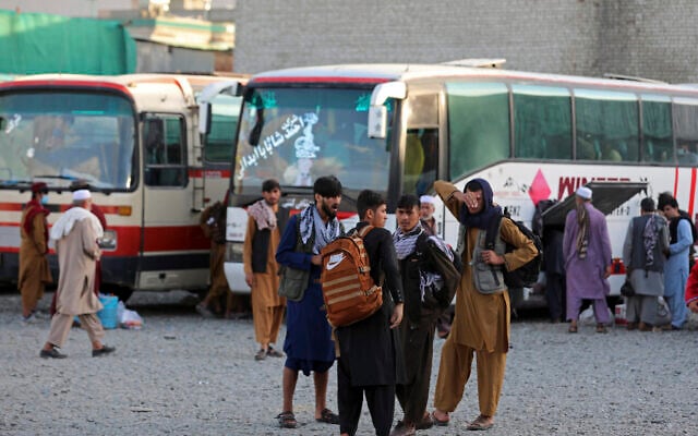 Illustrative: Afghans wait to board a bus to travel to Iran, in Kabul, Afghanistan, June 30, 2021. (AP/Rahmat Gul) Illustrative: Afghans wait to board a bus to travel to Iran, in Kabul, Afghanistan, June 30, 2021. (AP/Rahmat Gul)