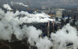 In this Nov. 28, 2019, file photo, smoke and steam rise from a coal processing plant in Hejin in central China's Shanxi Province. (AP Photo/Sam McNeil, File)
