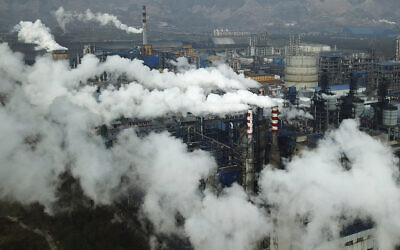 In this Nov. 28, 2019, file photo, smoke and steam rise from a coal processing plant in Hejin in central China's Shanxi Province. (AP Photo/Sam McNeil, File)