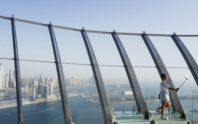 A woman takes a selfie photograph with the Dubai Marina behind her at The View at the Palm observation deck in Dubai, United Arab Emirates, July 19, 2021. (AP Photo/Jon Gambrell) A woman takes a selfie photograph with the Dubai Marina behind her at The View at the Palm observation deck in Dubai, United Arab Emirates, July 19, 2021. (AP Photo/Jon Gambrell)