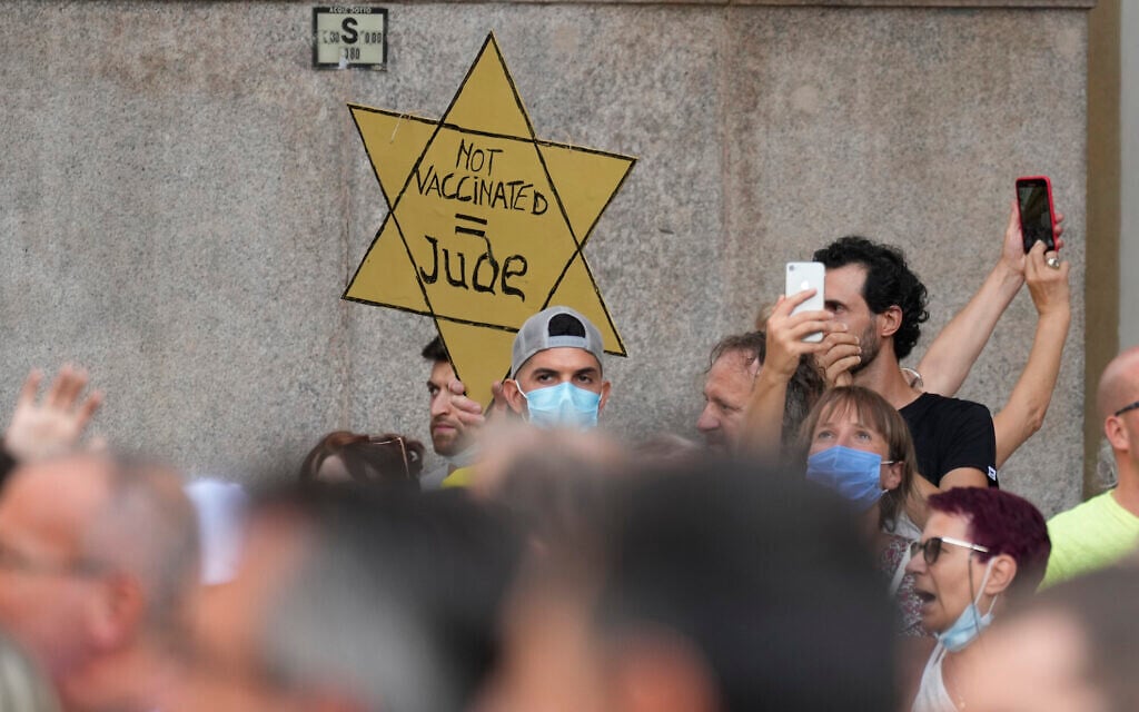 In this July 24, 2021, file photo, people stage a protest against the 'green pass' in Milan, Italy. Protesters in Italy and in France have been wearing yellow Stars of David, like the ones Nazis required Jews to wear to identify themselves during the Holocaust. Some carry signs likening vaccine passes to dictatorships. (AP Photo/Antonio Calanni, File) In this July 24, 2021, file photo, people stage a protest against the 'green pass' in Milan, Italy. Protesters in Italy and in France have been wearing yellow Stars of David, like the ones Nazis required Jews to wear to identify themselves during the Holocaust. Some carry signs likening vaccine passes to dictatorships. (AP Photo/Antonio Calanni, File)