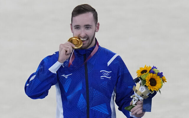 Artem Dolgopyat of Israel poses after winning the gold medal on the floor exercise during the artistic gymnastics men's apparatus final at the 2020 Summer Olympics, August 1, 2021, in Tokyo, Japan. (AP Photo/Gregory Bull)