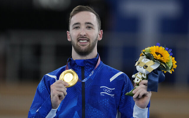 Artem Dolgopyat of Israel, poses after winning the gold medal after the floor exercise artistic gymnastics men's apparatus final at the 2020 Summer Olympics, on August 1, 2021, in Tokyo, Japan. (AP Photo/Natacha Pisarenko)