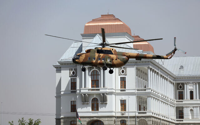 Illustrative: A helicopter carrying President Ashraf Ghani prepares to land at the Darul Aman Palace in Kabul, Afghanistan, August 2, 2021. (AP/Rahmat Gul) Illustrative: A helicopter carrying President Ashraf Ghani prepares to land at the Darul Aman Palace in Kabul, Afghanistan, August 2, 2021. (AP/Rahmat Gul)