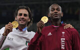 Joint gold medalists Mutaz Barshim, of Qatar, and Gianmarco Tamberi, left, of Italy pose for a photo following the men's high jump final at the 2020 Summer Olympics, Aug. 2, 2021, in Tokyo. (AP Photo/Francisco Seco)