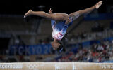 Simone Biles, of the United States, performs on the balance beam during the artistic gymnastics women's apparatus final at the 2020 Summer Olympics, Tuesday, Aug. 3, 2021, in Tokyo, Japan. (AP Photo/Ashley Landis)