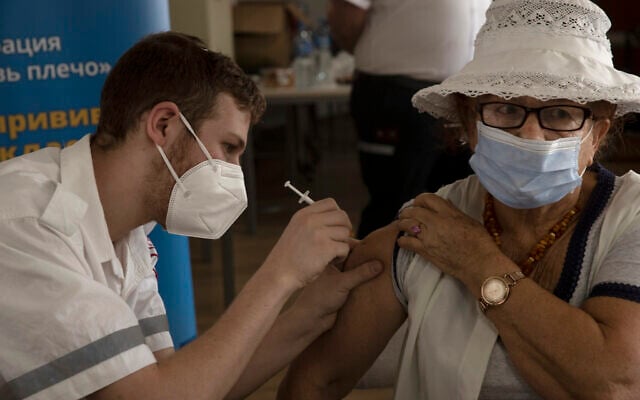 An Israeli woman receives a third coronavirus vaccine injection at a senior center in Jerusalem, August 4, 2021. (AP Photo/Maya Alleruzzo) An Israeli woman receives a third coronavirus vaccine injection at a senior center in Jerusalem, August 4, 2021. (AP Photo/Maya Alleruzzo)
