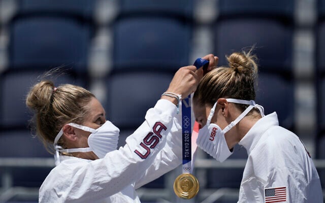 April Ross, left, of the United States, places the gold medal around the neck of teammate Alix Klineman, after winning a women's beach volleyball Gold Medal match against Australia at the 2020 Summer Olympics, Friday, Aug. 6, 2021, in Tokyo, Japan. (AP Photo/Felipe Dana) April Ross, left, of the United States, places the gold medal around the neck of teammate Alix Klineman, after winning a women's beach volleyball Gold Medal match against Australia at the 2020 Summer Olympics, Friday, Aug. 6, 2021, in Tokyo, Japan. (AP Photo/Felipe Dana)