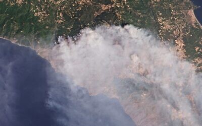This satellite photo provides by Planet Labs Inc. shows smoke rising from fires on the island of Evia, Greece, August 5, 2021. (Planet Labs Inc. via AP)