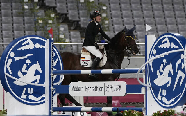 Annika Schleu of Germany cries as she couldn't controls her horse to compete in the equestrian portion of the women's modern pentathlon at the 2020 Summer Olympics, on August 6, 2021, in Tokyo, Japan. (AP Photo/Hassan Ammar) Annika Schleu of Germany cries as she couldn't controls her horse to compete in the equestrian portion of the women's modern pentathlon at the 2020 Summer Olympics, on August 6, 2021, in Tokyo, Japan. (AP Photo/Hassan Ammar)