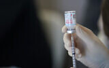 In this March 29, 2021 file photo, a worker readies syringes with the Moderna COVID-19 vaccine in Metairie, LA. (AP Photo/Gerald Herbert, File)