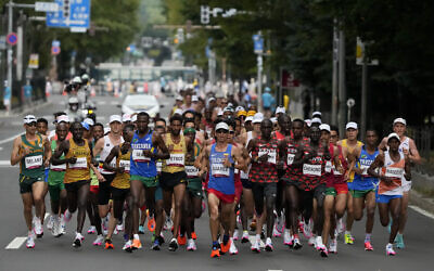 Runners compete during the men's marathon at the 2020 Summer Olympics on Aug. 8, 2021, in Sapporo, Japan. (AP/Shuji Kajiyama)