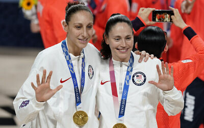 United States's Sue Bird, right, and Diana Taurasi pose with their gold medals during the medal ceremony for women's basketball at the 2020 Summer Olympics, in Saitama, Japan, August 8, 2021. (Charlie Neibergall/AP)