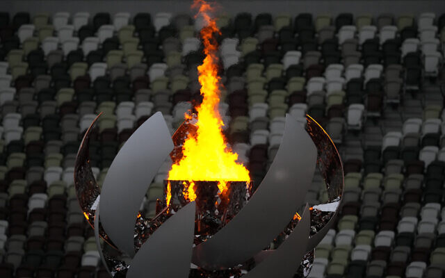 The Olympic flame burns prior to the closing ceremony in the Olympic Stadium at the 2020 Summer Olympics, August 8, 2021, in Tokyo, Japan. (AP Photo/Aaron Favila)