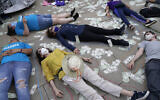 Illustrative: Protesters stage a die-in and have their shapes traced on the sidewalk outside the courthouse where the Purdue Pharma bankruptcy is taking place in White Plains, New York, August 9, 2021. (AP Photo/Seth Wenig)