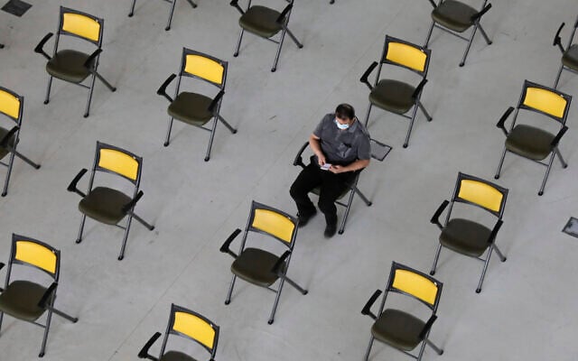 A man waits for his turn to receive Covid-19 vaccine at a vaccination center in Iran Mall shopping center in Tehran, Iran, August 9, 2021. (AP Photo/Vahid Salemi) A man waits for his turn to receive Covid-19 vaccine at a vaccination center in Iran Mall shopping center in Tehran, Iran, August 9, 2021. (AP Photo/Vahid Salemi)