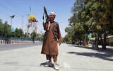 A Taliban fighter poses for a photo as he patrols inside the city of Ghazni, southwest of Kabul, Afghanistan, August 12, 2021. (Gulabuddin Amiri/AP)