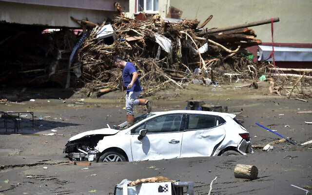 A man checks his car buried in the mud after floods and mudslides killed about three dozens of people, in Bozkurt town of Kastamonu province, Turkey, Friday, Aug. 13, 2021. (AP Photo) A man checks his car buried in the mud after floods and mudslides killed about three dozens of people, in Bozkurt town of Kastamonu province, Turkey, Friday, Aug. 13, 2021. (AP Photo)