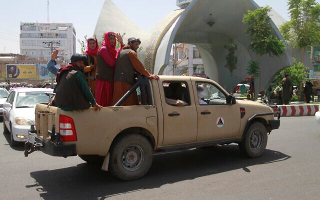 Taliban fighters pose on the back of a vehicle in the city of Herat, west of Kabul, Afghanistan, on August 14, 2021, after they took the province from Afghan government. (AP Photo/Hamed Sarfarazi) Taliban fighters pose on the back of a vehicle in the city of Herat, west of Kabul, Afghanistan, on August 14, 2021, after they took the province from Afghan government. (AP Photo/Hamed Sarfarazi)