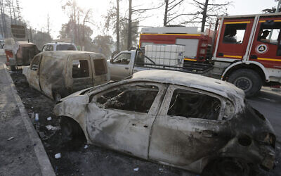 Charred cars are pictured after a fire near the village of Achlouf, in the Kabyle region, east of Algiers, August 13, 2021. (Toufik Doudou/AP)