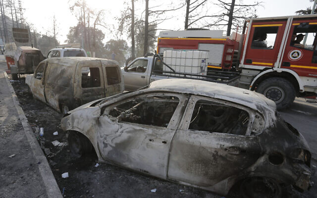 Charred cars are pictured after a fire near the village of Achlouf, in the Kabyle region, east of Algiers, August 13, 2021. (Toufik Doudou/AP) Charred cars are pictured after a fire near the village of Achlouf, in the Kabyle region, east of Algiers, August 13, 2021. (Toufik Doudou/AP)