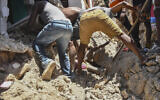 Several men work to rescue the body of a girl buried in the rubble of a house in the aftermath of an earthquake in Les Cayes, Haiti, August 14, 2021. (AP Photo / Duples Plymouth)