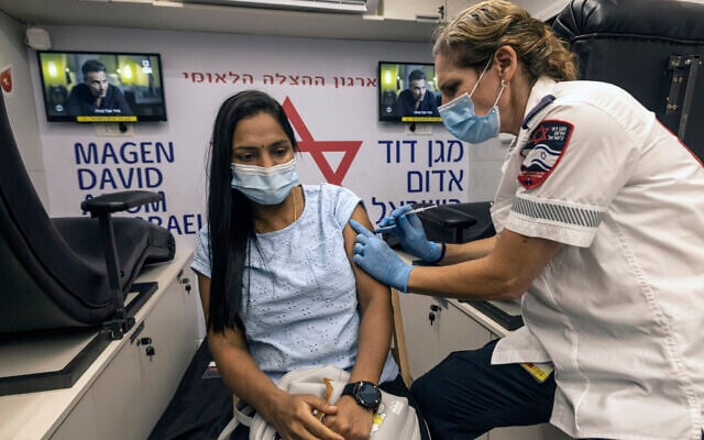 A medic from Israel's Magen David Adom emergency service administers a booster shot of the coronavirus vaccine to a woman in Tel Aviv, Israel, Aug. 14, 2021 (AP Photo/Tsafrir Abayov) A medic from Israel's Magen David Adom emergency service administers a booster shot of the coronavirus vaccine to a woman in Tel Aviv, Israel, Aug. 14, 2021 (AP Photo/Tsafrir Abayov)