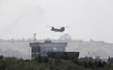 A US Chinook helicopter flies near the US Embassy in Kabul, Afghanistan,  Aug. 15, 2021 (AP Photo/Rahmat Gul)