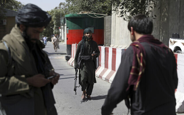Taliban fighters stand guard at a checkpoint on the road to the Afghan foreign ministry, in Kabul, Afghanistan, August 16, 2021. (AP Photo/Rahmat Gul)
