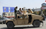 Taliban fighters stand guard in front of the Hamid Karzai International Airport, in Kabul, Afghanistan, August 16, 2021.  (AP Photo/Rahmat Gul)