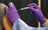 A man gets a COVID-19 vaccine at a mass vaccination site at the Natick Mall on February 24, 2021, in Natick, Massachusetts. (Matt Stone/The Boston Herald via AP, Pool)