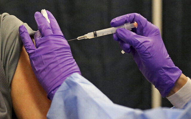 A man gets a COVID-19 vaccine at a mass vaccination site at the Natick Mall on February 24, 2021, in Natick, Massachusetts. (Matt Stone/The Boston Herald via AP, Pool) A man gets a COVID-19 vaccine at a mass vaccination site at the Natick Mall on February 24, 2021, in Natick, Massachusetts. (Matt Stone/The Boston Herald via AP, Pool)